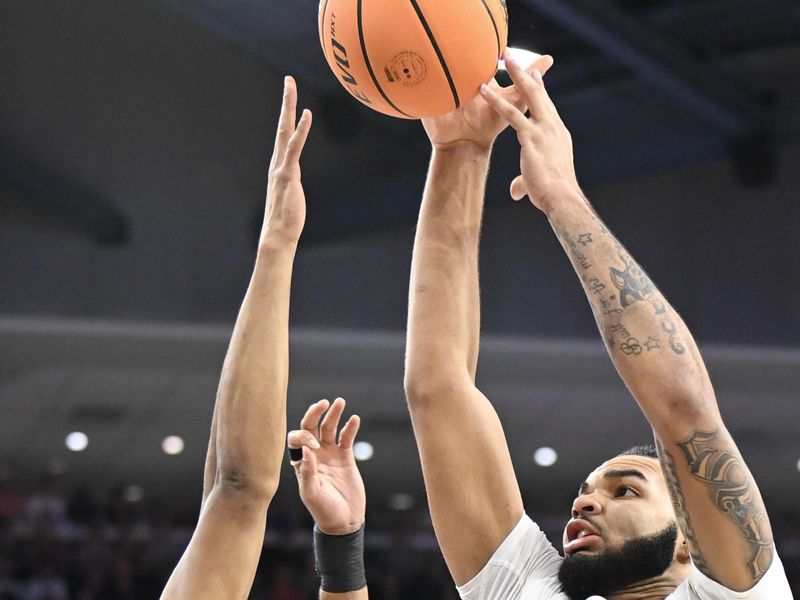 Feb 11, 2023; Auburn, Alabama, USA; Auburn Tigers forward Johni Broome (4) shoots over Alabama Crimson Tide forward Nimari Burnett (25) at Neville Arena. Mandatory Credit: Julie Bennett-USA TODAY Sports