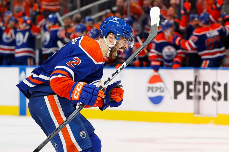 May 14, 2024; Edmonton, Alberta, CAN; Edmonton Oilers defensemen Evan Bouchard (2) celebrates after scoring a goal during the third period against the Vancouver Canucks in game four of the second round of the 2024 Stanley Cup Playoffs at Rogers Place. Mandatory Credit: Perry Nelson-USA TODAY Sports