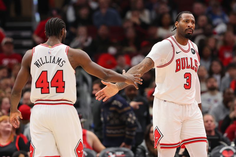 CHICAGO, ILLINOIS - DECEMBER 23: Andre Drummond #3 of the Chicago Bulls high fives Patrick Williams #44 against the Cleveland Cavaliers during the first half at the United Center on December 23, 2023 in Chicago, Illinois. NOTE TO USER: User expressly acknowledges and agrees that, by downloading and or using this photograph, User is consenting to the terms and conditions of the Getty Images License Agreement.  (Photo by Michael Reaves/Getty Images)