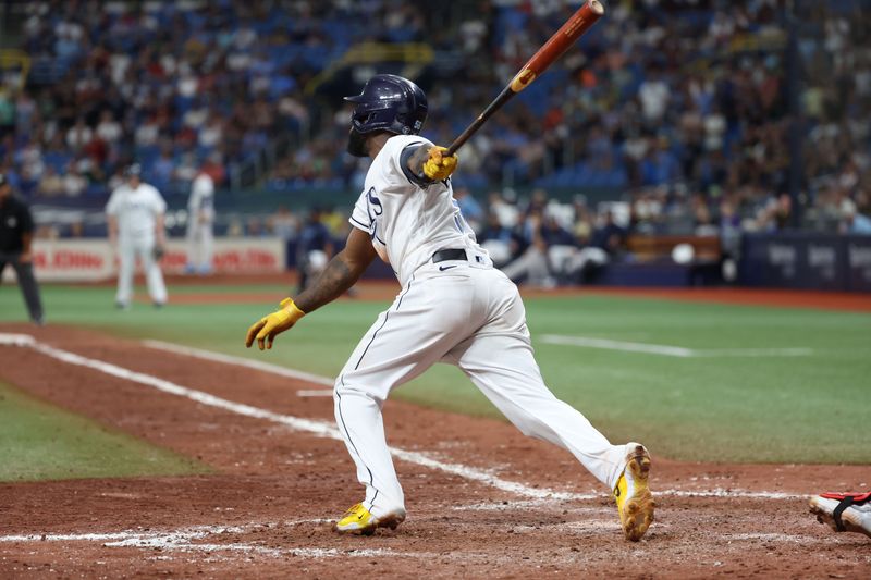 Aug 12, 2023; St. Petersburg, Florida, USA;  Tampa Bay Rays left fielder Randy Arozarena (56) hits a walk off RBI single against the Cleveland Guardians during the ninth inning at Tropicana Field. Mandatory Credit: Kim Klement Neitzel-USA TODAY Sports