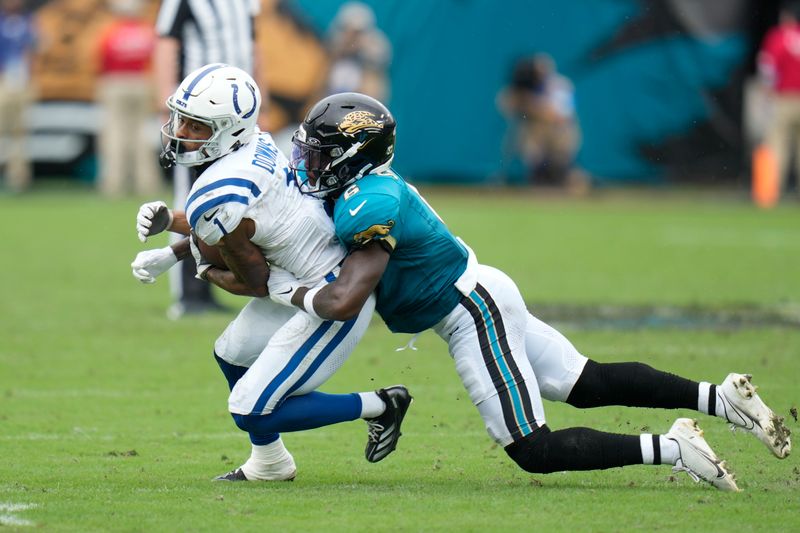 Indianapolis Colts' Josh Downs (1) is tackled by Jacksonville Jaguars' Darnell Savage (6) during the second half of an NFL football game, Sunday, Oct. 6, 2024, in Jacksonville, Fla. (AP Photo/John Raoux)