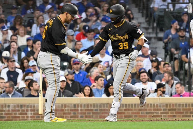 May 16, 2024; Chicago, Illinois, USA;  Pittsburgh Pirates second base Nick Gonzales (39) celebrates with catcher Yasmani Grandal (6) after hitting a home run against the Chicago Cubs during the fourth inning at Wrigley Field. Mandatory Credit: Matt Marton-USA TODAY Sports