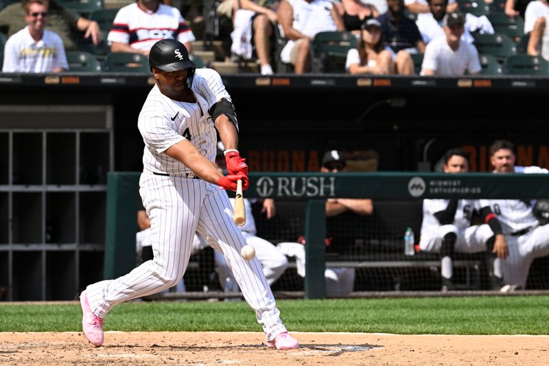 Jul 13, 2024; Chicago, Illinois, USA;  Chicago White Sox designated hitter Eloy Jiménez (74) hits into an RBI ground out during the eighth inning against the Pittsburgh Pirates at Guaranteed Rate Field. Mandatory Credit: Matt Marton-USA TODAY Sports