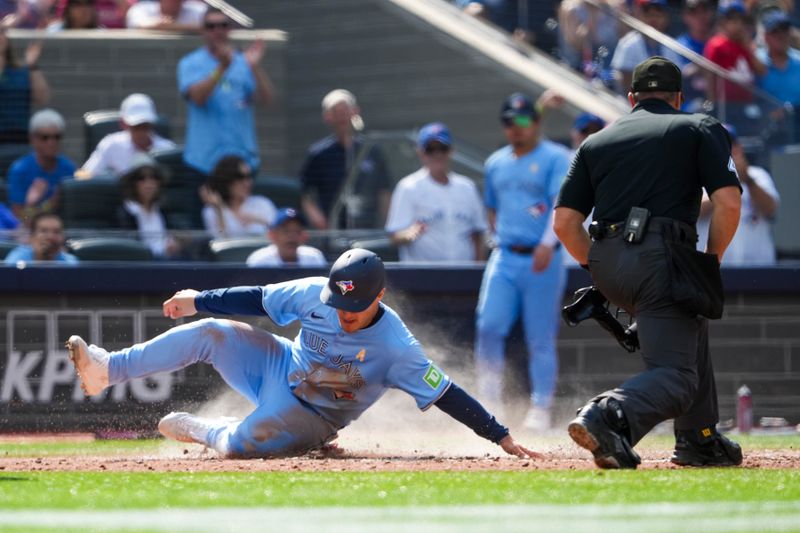 Sep 14, 2025; Toronto, Ontario, CAN; Toronto Blue Jays outfielder Daulton Varsho (5) slides into home plate to score against the Baltimore Orioles during the fourth inning at Rogers Centre. Mandatory Credit: Kevin Sousa-Imagn Images