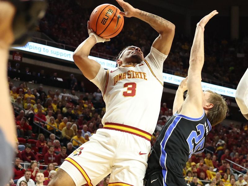 Mar 4, 2025; Ames, Iowa, USA; Brigham Young Cougars guard Dawson Baker (25) defends Iowa State Cyclones guard Tamin Lipsey (3) at James H. Hilton Coliseum. Mandatory Credit: Reese Strickland-Imagn Images