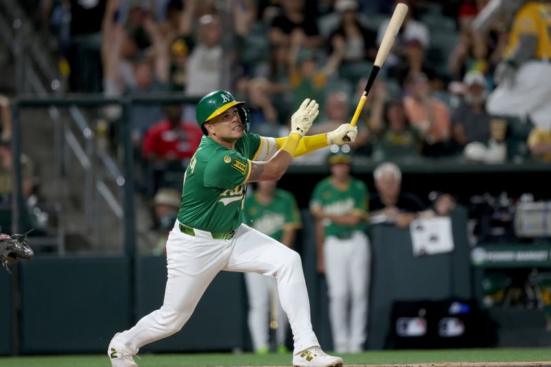 May 19, 2025; West Sacramento, California, USA; Athletics third baseman Gio Urshela (13) watches his ball soar towards foul territory against the Los Angeles Angels during the sixth inning at Sutter Health Park. Mandatory Credit: Dennis Lee-Imagn Images