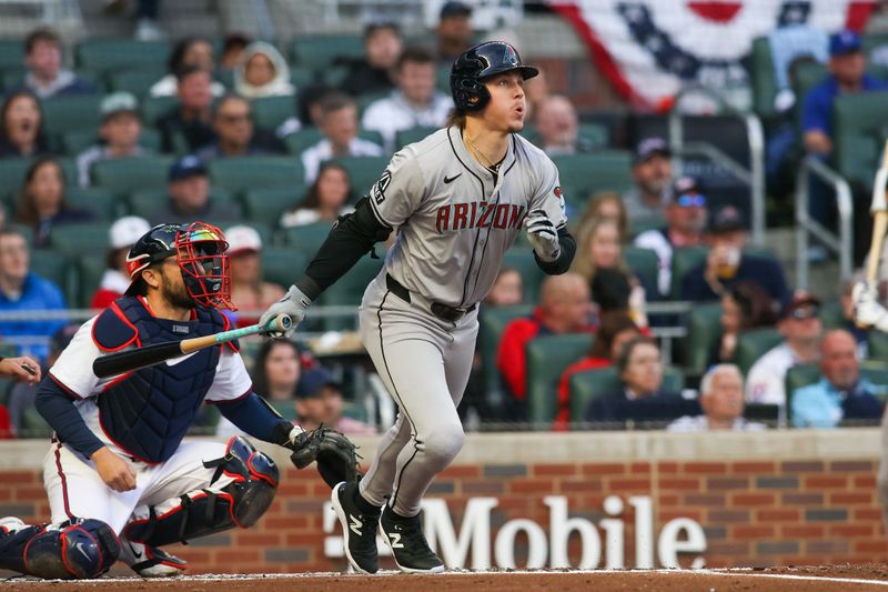 Apr 6, 2024; Atlanta, Georgia, USA; Arizona Diamondbacks right fielder Jake McCarthy (31) hits a RBI single against the Atlanta Braves in the first inning at Truist Park. Mandatory Credit: Brett Davis-USA TODAY Sports