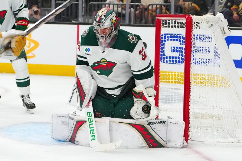 Apr 29, 2025; Las Vegas, Nevada, USA; Minnesota Wild goaltender Filip Gustavsson (32) makes a save against the Vegas Golden Knights during the second period of game five of the first round of the 2025 Stanley Cup Playoffs at T-Mobile Arena. Mandatory Credit: Stephen R. Sylvanie-Imagn Images