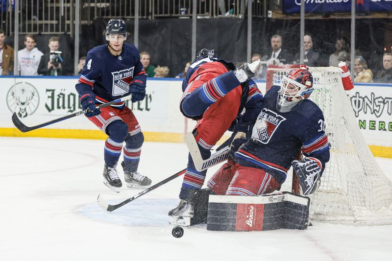 Mar 17, 2024; New York, New York, USA; New York Rangers goaltender Igor Shesterkin (31) makes a save against the New York Islanders in front of defenseman Ryan Lindgren (55) and defenseman Braden Schneider (4) during the first period at Madison Square Garden. Mandatory Credit: Vincent Carchietta-USA TODAY Sports