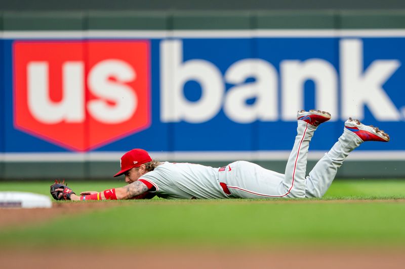 Jul 23, 2024; Minneapolis, Minnesota, USA; Philadelphia Phillies second baseman Bryson Stott (5) dives for a ground ball against the Minnesota Twins in the second inning at Target Field. Mandatory Credit: Jesse Johnson-USA TODAY Sports