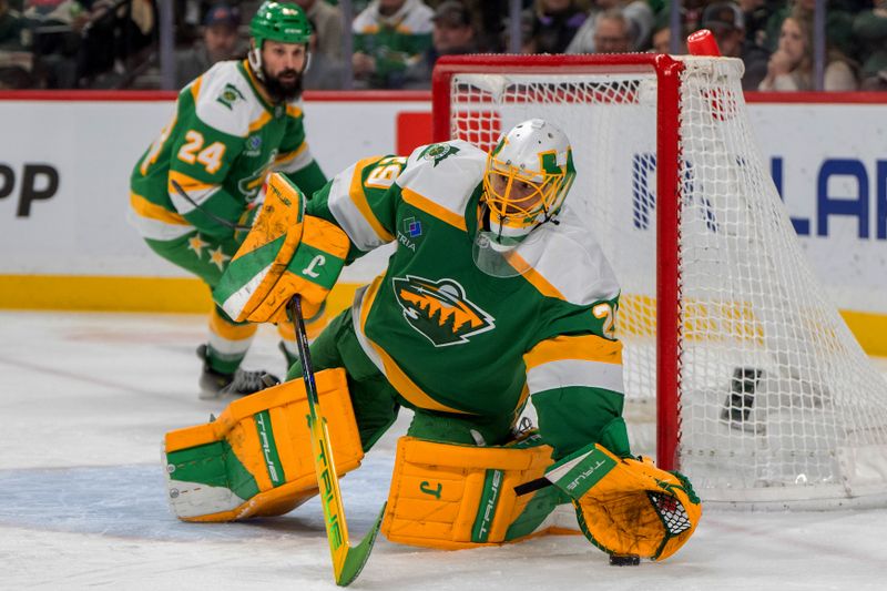 Jan 25, 2025; Saint Paul, Minnesota, USA; Minnesota Wild goaltender Marc-Andre Fleury (29) blocks the puck with his glove against the Calgary Flames in the third period at Xcel Energy Center. Mandatory Credit: Matt Blewett-Imagn Images