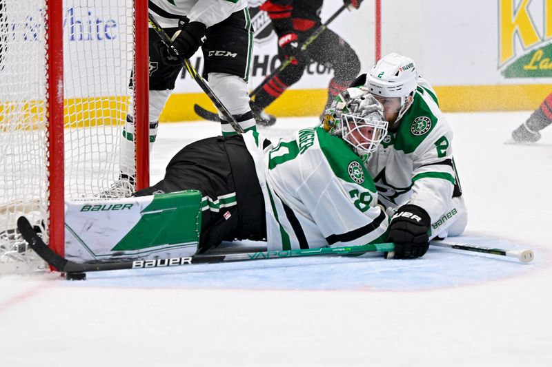 Jan 25, 2023; Dallas, Texas, USA; Dallas Stars goaltender Jake Oettinger (29) and defenseman Jani Hakanpaa (2) keep the puck out of the net during the first period against the Carolina Hurricanes at the American Airlines Center. Mandatory Credit: Jerome Miron-USA TODAY Sports