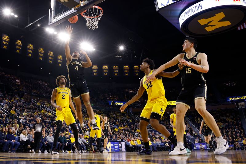 Feb 25, 2024; Ann Arbor, Michigan, USA;  Purdue Boilermakers forward Trey Kaufman-Renn (4) shoots on Michigan Wolverines forward Tray Jackson (2) in the second half at Crisler Center. Mandatory Credit: Rick Osentoski-USA TODAY Sports