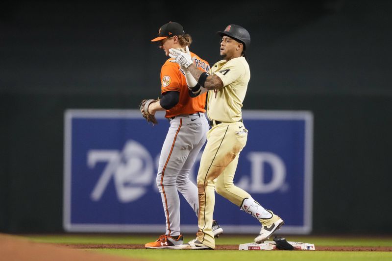 Sep 2, 2023; Phoenix, Arizona, USA; Arizona Diamondbacks second baseman Ketel Marte (4) celebrates in front of Baltimore Orioles shortstop Gunnar Henderson (2) after hitting a double during the third inning at Chase Field. Mandatory Credit: Joe Camporeale-USA TODAY Sports