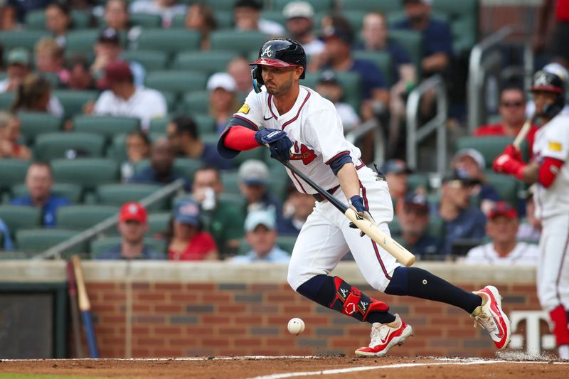 Jun 18, 2024; Atlanta, Georgia, USA; Atlanta Braves right fielder Forrest Wall (37) bunts for a base hit against the Detroit Tigers in the second inning at Truist Park. Mandatory Credit: Brett Davis-USA TODAY Sports
