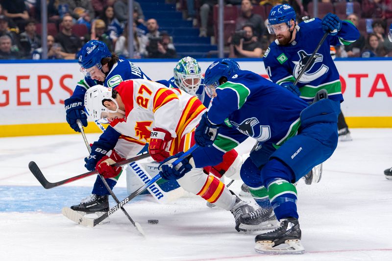 Nov 12, 2024; Vancouver, British Columbia, CAN; Vancouver Canucks defenseman Quinn Hughes (43) and forward Conor Garland (8) battle with Calgary Flames forward Matt Coronato (27) during the first period at Rogers Arena. Mandatory Credit: Bob Frid-Imagn Images