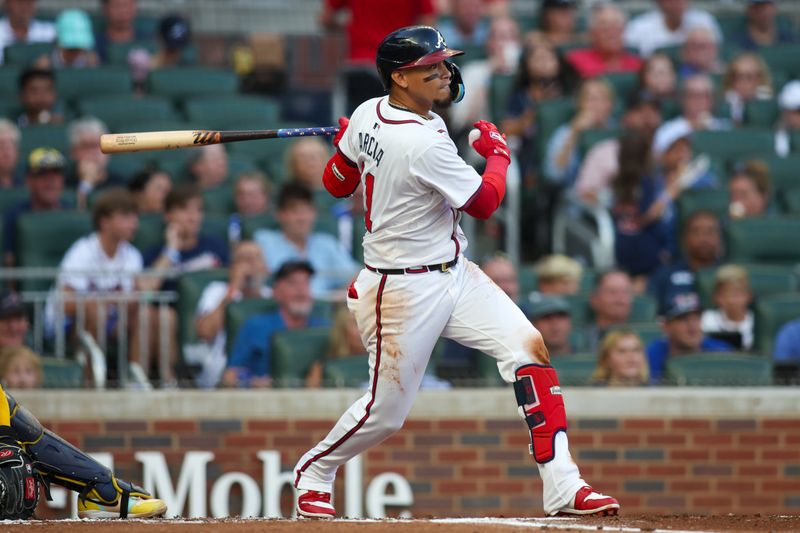 Aug 7, 2024; Atlanta, Georgia, USA; Atlanta Braves shortstop Orlando Arcia (11) hits a single against the Milwaukee Brewers in the first inning at Truist Park. Mandatory Credit: Brett Davis-USA TODAY Sports
