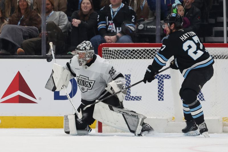 Apr 3, 2025; Salt Lake City, Utah, USA; Los Angeles Kings goaltender Darcy Kuemper (35) blocks a shot as Utah Hockey Club center Barrett Hayton (27) wait for a rebound during the first period at Delta Center. Mandatory Credit: Rob Gray-Imagn Images