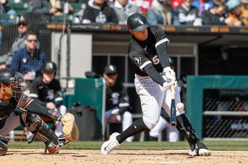 Apr 6, 2023; Chicago, Illinois, USA; Chicago White Sox first baseman Andrew Vaughn (25) hits an RBI single against the San Francisco Giants during the fourth inning at Guaranteed Rate Field. Mandatory Credit: Kamil Krzaczynski-USA TODAY Sports