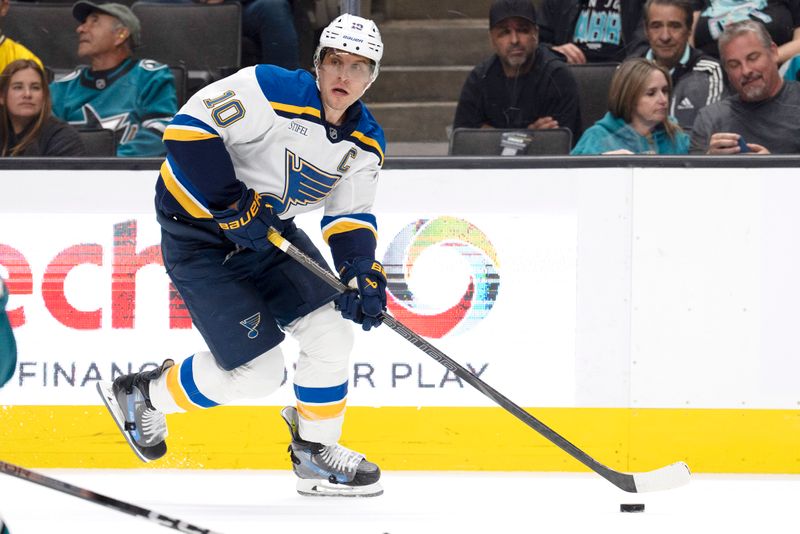 Oct 10, 2024; San Jose, California, USA;  St. Louis Blues center Brayden Schenn (10) controls the puck during the second period against the San Jose Sharks at SAP Center at San Jose. Mandatory Credit: Stan Szeto-Imagn Images