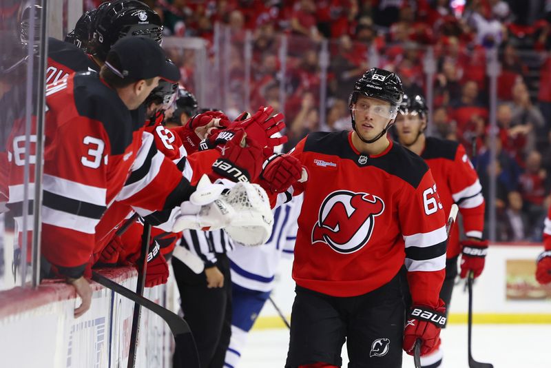 Oct 10, 2024; Newark, New Jersey, USA; New Jersey Devils left wing Jesper Bratt (63) celebrates his goal with teammates against the Toronto Maple Leafs during the first period at Prudential Center. Mandatory Credit: Ed Mulholland-Imagn Images