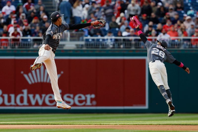 Apr 6, 2024; Washington, District of Columbia, USA; Washington Nationals outfielder Jesse Winker (6) attempts to catch a line drive hit by Philadelphia Phillies second baseman Bryson Stott (not pictured) as Nationals third baseman Trey Lipscomb (38) looks on during the seventh inning at Nationals Park. Mandatory Credit: Geoff Burke-USA TODAY Sports