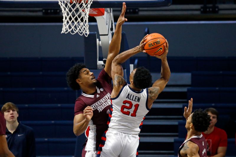 Feb 18, 2023; Oxford, Mississippi, USA; Mississippi State Bulldogs forward Tolu Smith (1) defends as Mississippi Rebels forward Robert Allen (21) shoots during the first half at The Sandy and John Black Pavilion at Ole Miss. Mandatory Credit: Petre Thomas-USA TODAY Sports