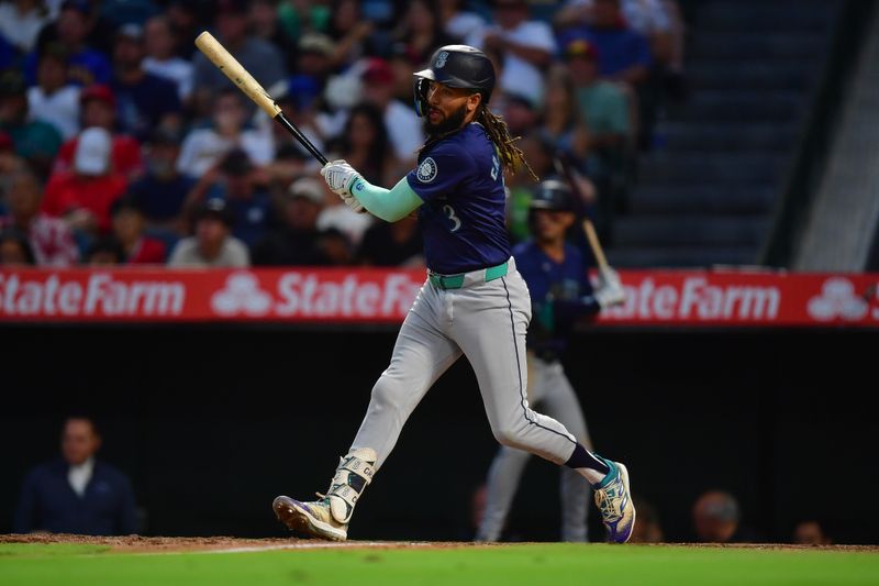 Jul 11, 2024; Anaheim, California, USA; Seattle Mariners shortstop J.P. Crawford (3) hits an RBI single against the Los Angeles Angels during the sixth inning at Angel Stadium. Mandatory Credit: Gary A. Vasquez-USA TODAY Sports