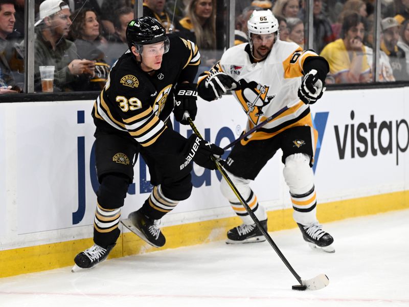 Mar 9, 2024; Boston, Massachusetts, USA; Boston Bruins center Morgan Geekie (39) controls the puck against Pittsburgh Penguins defenseman Erik Karlsson (65) during the first period at the TD Garden. Mandatory Credit: Brian Fluharty-USA TODAY Sports