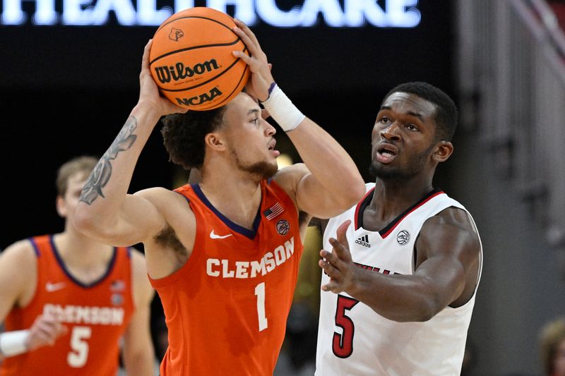 Feb 18, 2023; Louisville, Kentucky, USA;  Clemson Tigers guard Chase Hunter (1) looks to pass under the pressure of Louisville Cardinals forward Brandon Huntley-Hatfield (5) during the second half at KFC Yum! Center. Louisville defeated Clemson 83-73. Mandatory Credit: Jamie Rhodes-USA TODAY Sports