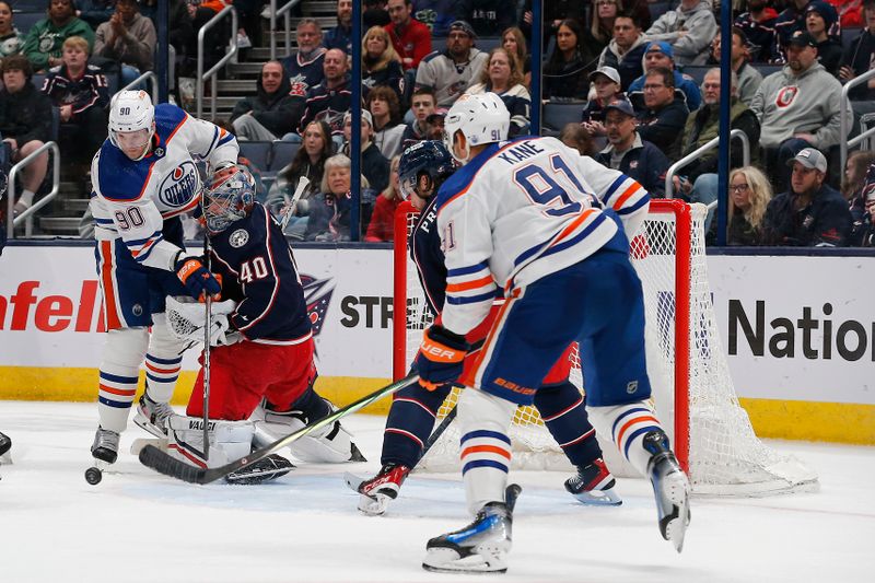 Mar 7, 2024; Columbus, Ohio, USA; Edmonton Oilers right wing Corey Perry (90) collides with Columbus Blue Jackets goalie Daniil Tarasov (40) as he makes a save during the second period at Nationwide Arena. Mandatory Credit: Russell LaBounty-USA TODAY Sports