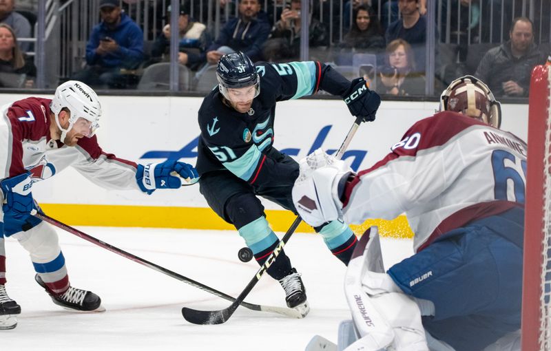 Oct 22, 2024; Seattle, Washington, USA;  Seattle Kraken forward Shane Wright (51) attempts a shot against Colorado Avalanche goalie Justus Annunen (60) during the second period at Climate Pledge Arena. Mandatory Credit: Stephen Brashear-Imagn Images