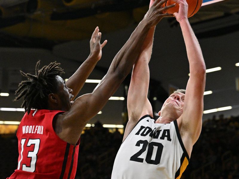 Jan 6, 2024; Iowa City, Iowa, USA; Iowa Hawkeyes forward Payton Sandfort (20) and Rutgers Scarlet Knights forward Antwone Woolfolk (13) battle for a rebound during the first half at Carver-Hawkeye Arena. Mandatory Credit: Jeffrey Becker-USA TODAY Sports