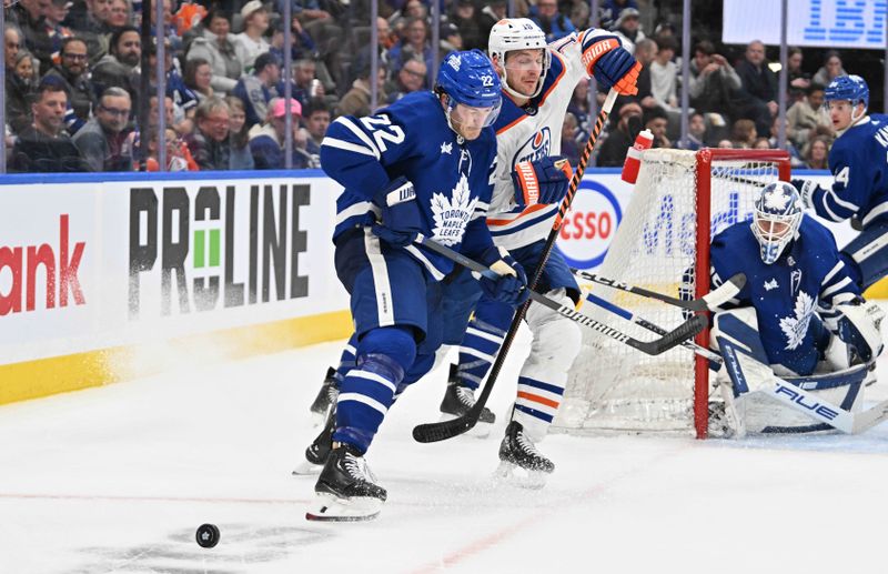 Mar 23, 2024; Toronto, Ontario, CAN; Toronto Maple Leafs defenseman Jake McCabe (22) knocks Edmonton Oilers forward Zach Hyman (18) off the puck in the second period at Scotiabank Arena. Mandatory Credit: Dan Hamilton-USA TODAY Sports