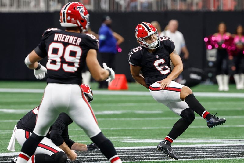 Atlanta Falcons place kicker Younghoe Koo, of South Korea, kicks a game winning 58-yard field goal against the New Orleans Saints during the second half of an NFL football game, Sunday, Sept. 29, 2024, in Atlanta. (AP Photo/Butch Dill)