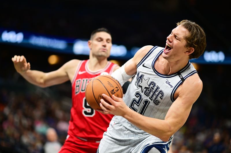 ORLANDO, FLORIDA - NOVEMBER 27: Moritz Wagner #21 of the Orlando Magic reacts after a foul from Nikola Vucevic #9 of the Chicago Bulls in the first half of a game at Kia Center on November 27, 2024 in Orlando, Florida. NOTE TO USER: User expressly acknowledges and agrees that, by downloading and or using this photograph, User is consenting to the terms and conditions of the Getty Images License Agreement. (Photo by Julio Aguilar/Getty Images)