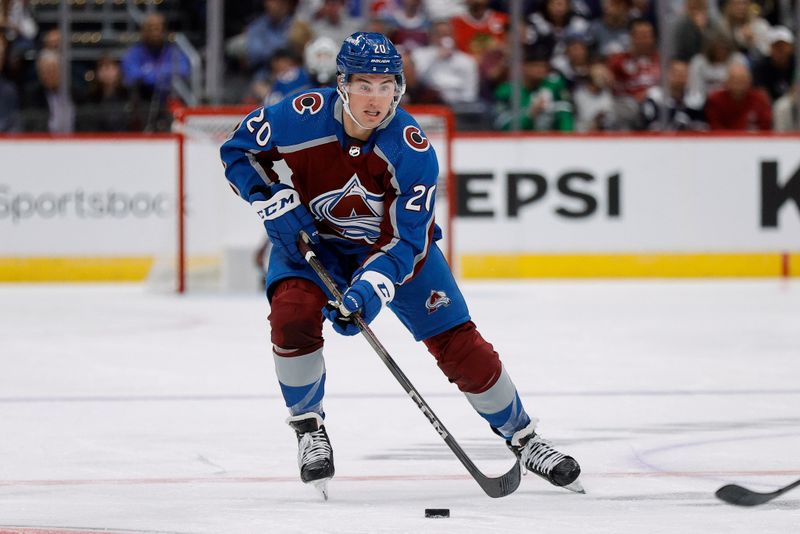 Oct 19, 2023; Denver, Colorado, USA; Colorado Avalanche center Ross Colton (20) controls the puck in the second period against the Chicago Blackhawks at Ball Arena. Mandatory Credit: Isaiah J. Downing-USA TODAY Sports