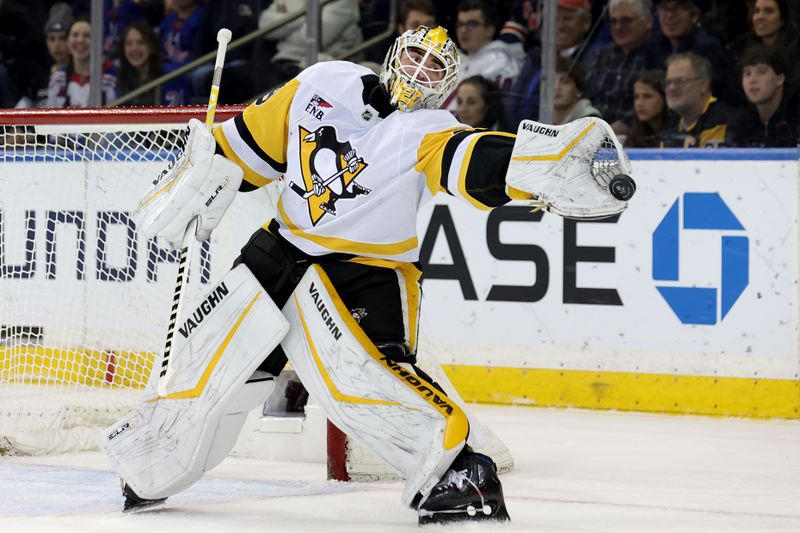 Dec 6, 2024; New York, New York, USA; Pittsburgh Penguins goaltender Alex Nedeljkovic (39) plays the puck against the New York Rangers during the first period at Madison Square Garden. Mandatory Credit: Brad Penner-Imagn Images