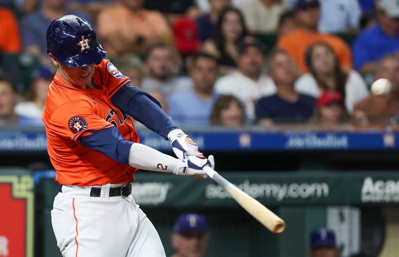 Jul 12, 2024; Houston, Texas, USA; Houston Astros third baseman Alex Bregman (2) hits a home run against the Texas Rangers in the fifth inning at Minute Maid Park. Mandatory Credit: Thomas Shea-USA TODAY Sports