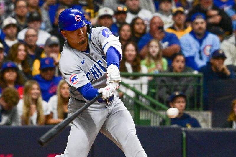 May 2, 2025; Milwaukee, Wisconsin, USA; Chicago Cubs designated hitter Seiya Suzuki (27) drives in a run with a base hit in the second inning against the Milwaukee Brewers at American Family Field. Mandatory Credit: Benny Sieu-Imagn Images