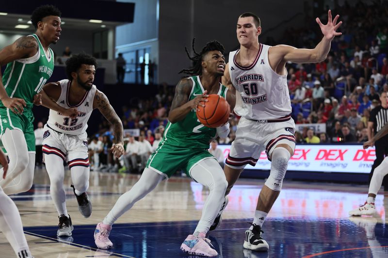 Jan 28, 2024; Boca Raton, Florida, USA; North Texas Mean Green guard Jason Edwards (2) drives to the basket against Florida Atlantic Owls center Vladislav Goldin (50) during the first half at Eleanor R. Baldwin Arena. Mandatory Credit: Sam Navarro-USA TODAY Sports