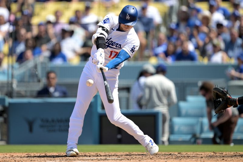 Apr 17, 2024; Los Angeles, California, USA; Los Angeles Dodgers designated hitter player Shohei Ohtani (17) singles in the eighth inning against the Washington Nationals at Dodger Stadium. Mandatory Credit: Jayne Kamin-Oncea-USA TODAY Sports