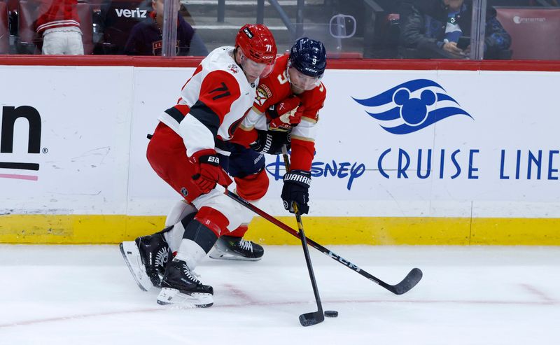 Dec 19, 2025; Sunrise, Florida, USA;  Carolina Hurricanes left wing Taylor Hall (71) and Florida Panthers center Sam Bennett (9) fight for the puck during the first period at Amerant Bank Arena. Mandatory Credit: Rhona Wise-Imagn Images