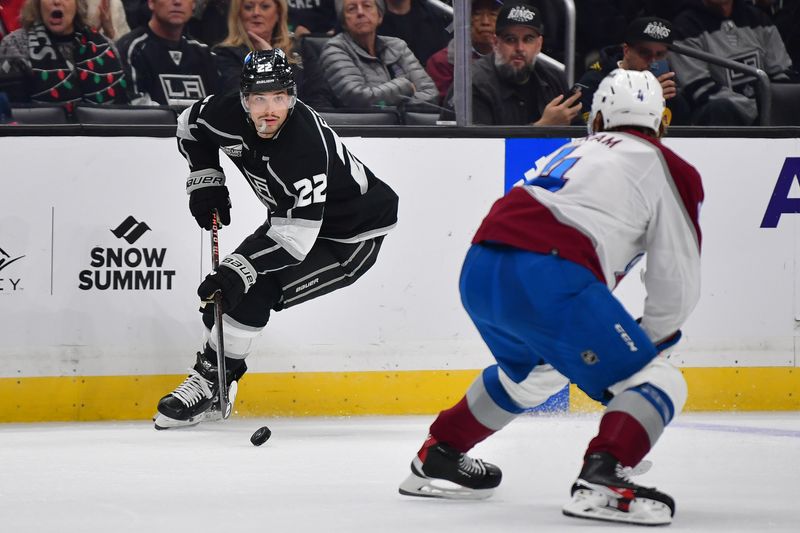 Dec 3, 2023; Los Angeles, California, USA; Los Angeles Kings left wing Kevin Fiala (22) moves the puck against Colorado Avalanche defenseman Bowen Byram (4) during the second period at Crypto.com Arena. Mandatory Credit: Gary A. Vasquez-USA TODAY Sports