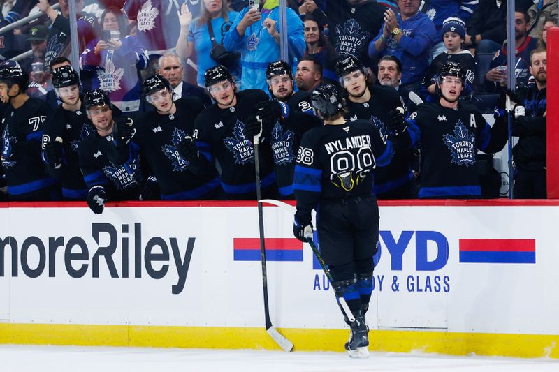 Oct 28, 2024; Winnipeg, Manitoba, CAN; Toronto Maple Leafs forward William Nylander (88) celebrates with teammates after scoring a goal against the Winnipeg Jets during the first period at Canada Life Centre. Mandatory Credit: Terrence Lee-Imagn Images