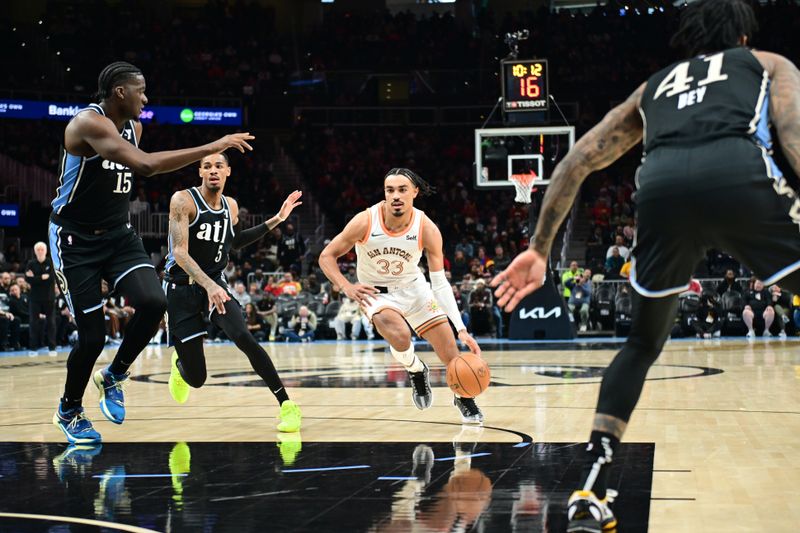 ATLANTA, GA - JANUARY 15: Tre Jones #33 of the San Antonio Spurs drives to the basket during the game against the Atlanta Hawks on January 15, 2024 at State Farm Arena in Atlanta, Georgia.  NOTE TO USER: User expressly acknowledges and agrees that, by downloading and/or using this Photograph, user is consenting to the terms and conditions of the Getty Images License Agreement. Mandatory Copyright Notice: Copyright 2024 NBAE (Photo by Adam Hagy/NBAE via Getty Images)