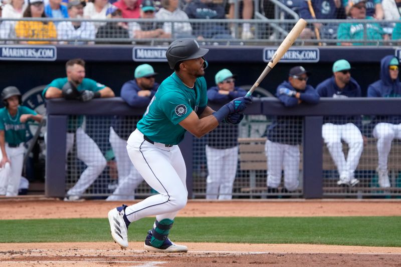 Mar 24, 2024; Peoria, Arizona, USA; Seattle Mariners center fielder Julio Rodriguez (44) hits a single against the Chicago Cubs in the first inning at Peoria Sports Complex. Mandatory Credit: Rick Scuteri-USA TODAY Sports