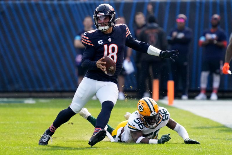 Chicago Bears' Caleb Williams runs past Green Bay Packers' Edgerrin Cooper during the first half of an NFL football game Sunday, Nov. 17, 2024, in Chicago. (AP Photo/Nam Y. Huh)