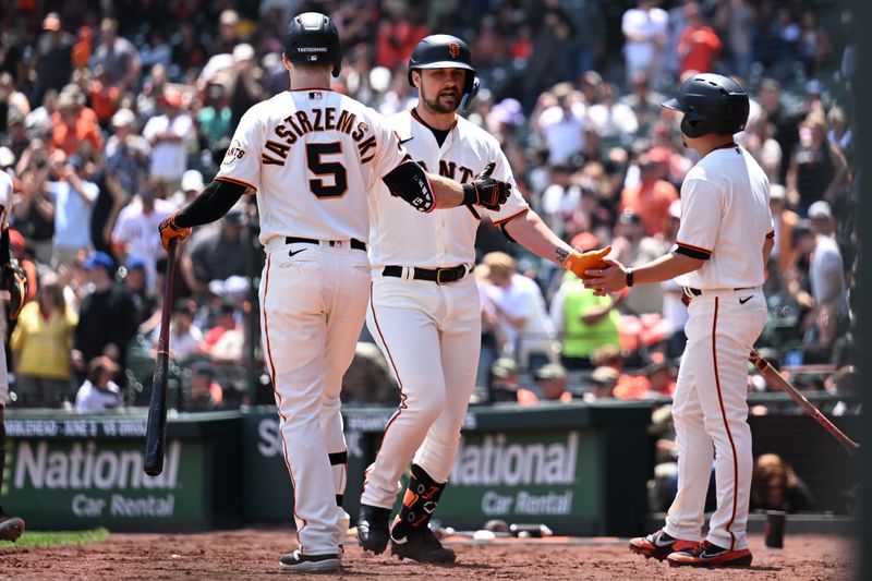 May 21, 2023; San Francisco, California, USA; San Francisco Giants designated hitter J.D. Davis (7) shakes hands with outfielder Mike Yastrzemski (5) after hitting a solo home run against the Miami Marlins during the third inning at Oracle Park. Mandatory Credit: Robert Edwards-USA TODAY Sports