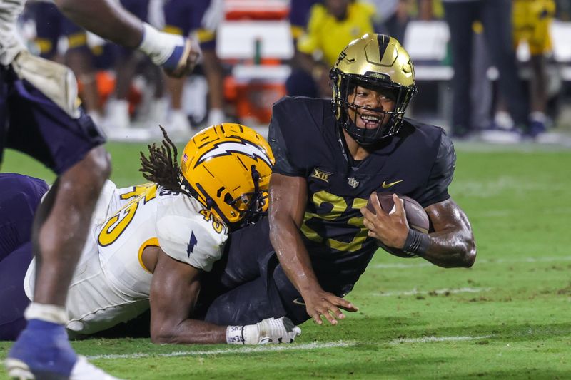 Aug 31, 2023; Orlando, Florida, USA; UCF Knights running back Demarkcus Bowman (23) is tackled by Kent State Golden Flashes linebacker Khali Saunders (45) during the second half at FBC Mortgage Stadium. Mandatory Credit: Mike Watters-USA TODAY Sports battle for the ball